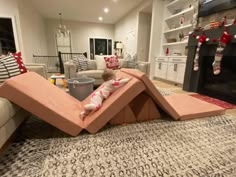 a child is playing in the living room with a couch and chair that has been made out of cardboard