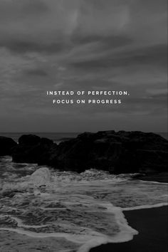 black and white photo with the words instead of perfection focus on progress in front of an ocean