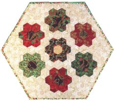 a quilted hexagonal table topper with red, green and gold flowers