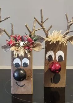 two paper bags decorated with reindeer heads and decorations