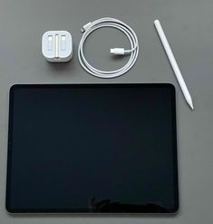 an apple ipad and some accessories on a table