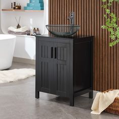 a bathroom sink sitting next to a white bath tub in a room with wooden walls