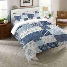 a blue and white quilted bed in a bedroom