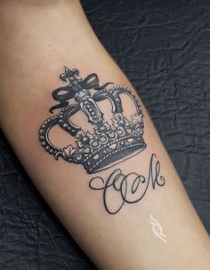 a black and white photo of a crown with the word god on it's arm