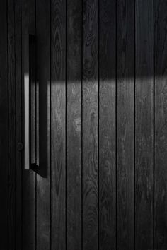 an open door is shown in black and white with the light coming from behind it