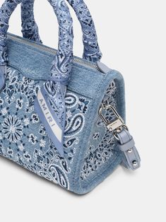 House signature motifs adorn iconic forms in new, seasonal fabrications for Pre-Fall 2024. The denim Bandana Micro Triangle Bag is embroidered with the house's bandana paisley and features top handles with tied paisley scarf accents and a detachable denim shoulder strap. PRE-FALL 2024 COLLECTION MADE IN ITALY 100% COTTON Bandana Bag, Denim Bandana, Paisley Scarf, Triangle Bag, Paisley Scarves, Vintage Jerseys, Crossbody Tote Bag, Denim Bag, New Sneakers