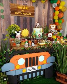 a safari themed birthday party with an orange jeep cake and desserts on the table