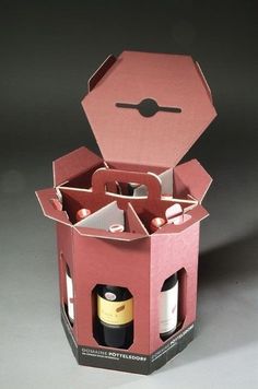 an open pink box filled with bottles of wine