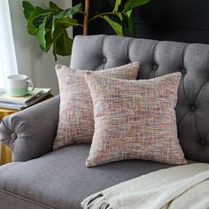 a gray couch with two pillows on it