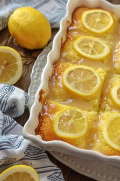 a dish with lemon cake and sliced lemons on the side