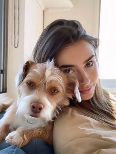 a woman holding a dog on her lap