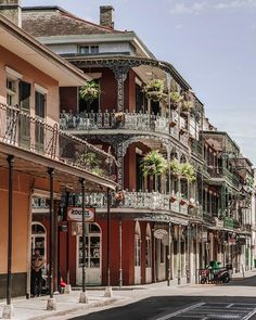 an empty street with many balconies on the buildings