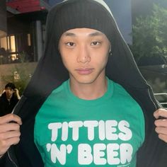 a young man wearing a green shirt that says tittles n'beer