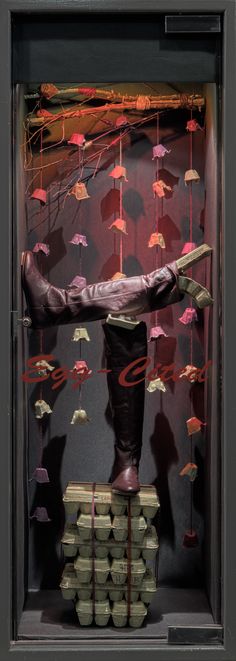 a display case filled with lots of money and umbrellas hanging from it's sides