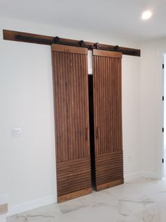 an empty room with two wooden sliding doors