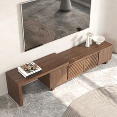 a wooden table sitting in front of a mirror next to a vase and bowl on the floor