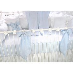 a baby crib with blue and white bedding