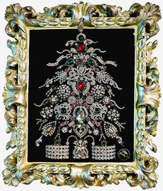 an ornate gold frame with a christmas tree in the center and red, green, white, and blue beads on it