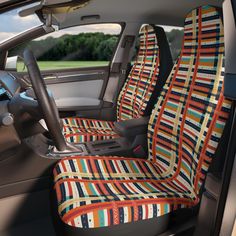 the interior of a car is decorated with multicolored stripes and strips on it's seat covers