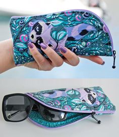 a woman's hand holding an eyeglass case with sunglasses in it and the inside of her purse