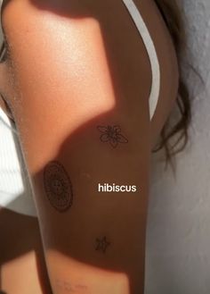 a woman's arm with tattoos on it and the words hilscuss