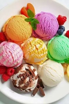 a white plate topped with different colored ice creams