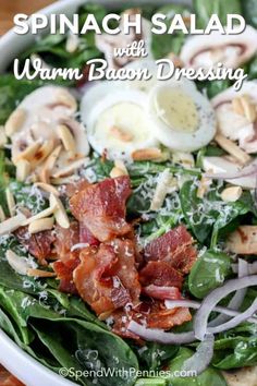 spinach salad with warm bacon dressing in a white bowl