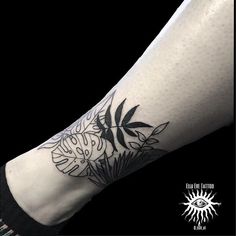 a black and white photo of a person's arm with a tattoo on it