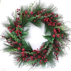 a christmas wreath with red berries and greenery