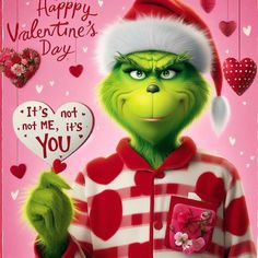 the grinch from the grinch movie is wearing a santa hat and holding a heart