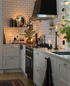 a kitchen filled with lots of white cabinets and counter top space next to a window