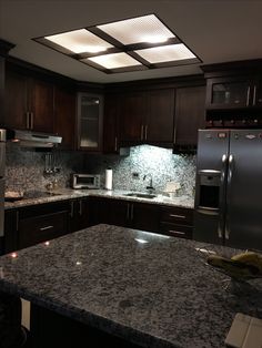 a kitchen with granite counter tops and stainless steel appliances