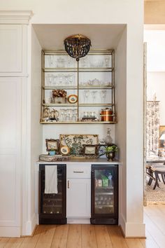 a kitchen with white walls and wooden floors