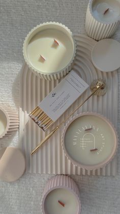 some candles and plates on a table with tags attached to the top one is empty