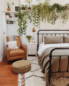 a bed room with a neatly made bed and lots of plants