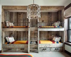 a room with bunk beds and drawers in it