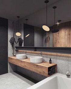 a bathroom with two sinks and a large mirror above the bathtub in front of it