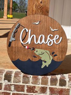 a wooden sign that says chase with a fish on it