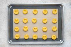 doughnut holes on a baking sheet with yellow icing