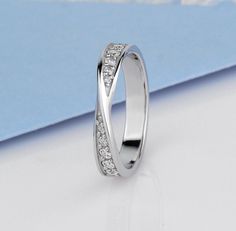 a white gold wedding ring with diamonds