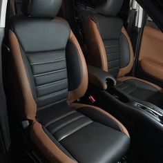 the interior of a car with black and tan leather seats