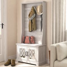 a coat rack with shoes, purses and hats hanging on it in a living room