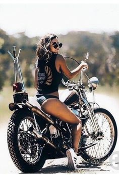 a woman riding on the back of a motorcycle