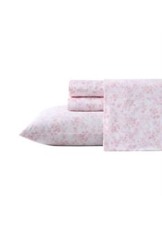 the pink sheets and pillowcases are made from floral print, with two pillows on each side