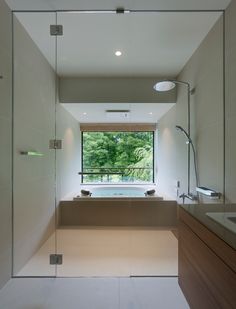 a bathroom with a large window, sink and bathtub in the middle of it