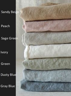 towels stacked on top of each other in different colors and sizes, with the words sandy bed