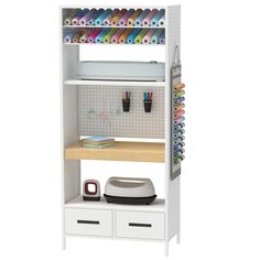 a white bookcase with two drawers and some crafting supplies on the top shelf