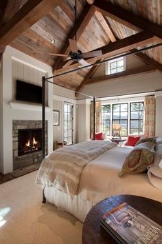 a large bedroom with a fireplace in the corner