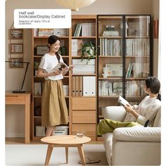 two women are reading books in the living room