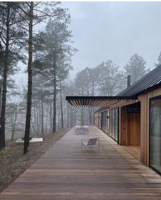 a wooden walkway leading to a house in the woods